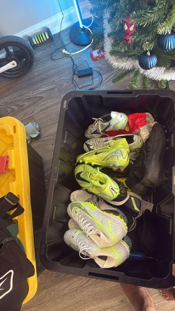 A bin filled with donated football boots